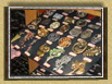 A collection of fancy buttons, lapel pins and broaches. Some are political, patriotic, or just beautiful!.